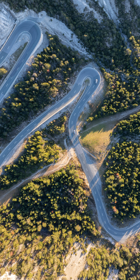 Vogelperspektive auf die markanten Serpentinen des Umbrailpasses in hochalpiner Umgebung.